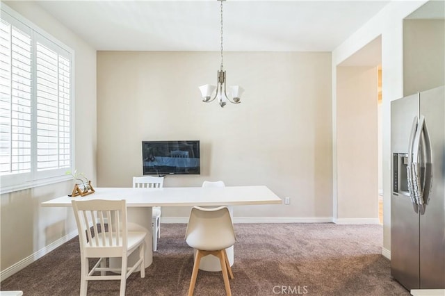 dining area featuring baseboards, dark colored carpet, and a notable chandelier