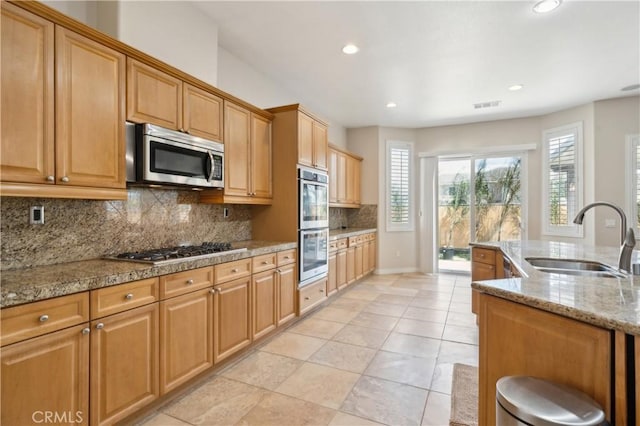 kitchen with tasteful backsplash, recessed lighting, visible vents, appliances with stainless steel finishes, and a sink