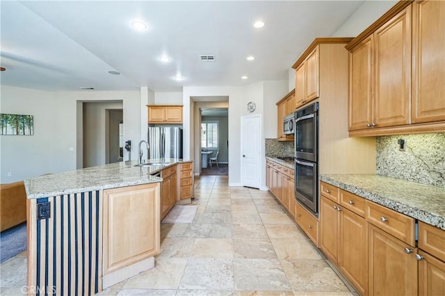 kitchen featuring visible vents, recessed lighting, a sink, stainless steel appliances, and decorative backsplash