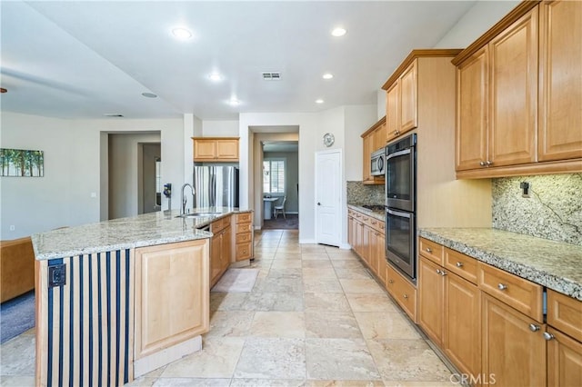 2 Villa Roma St, Lake Elsinore, CA 92532 - kitchen featuring appliances with stainless steel finishes, decorative backsplash, recessed lighting, an island with sink, and stone tile flooring