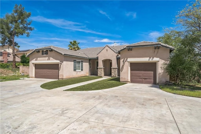 ranch-style home featuring concrete driveway, stucco siding, and an attached garage