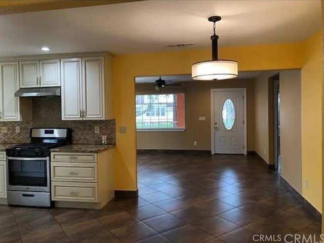 1586 Link St, Corning, CA 96021 - kitchen with baseboards, stainless steel gas range oven, a ceiling fan, backsplash, and under cabinet range hood