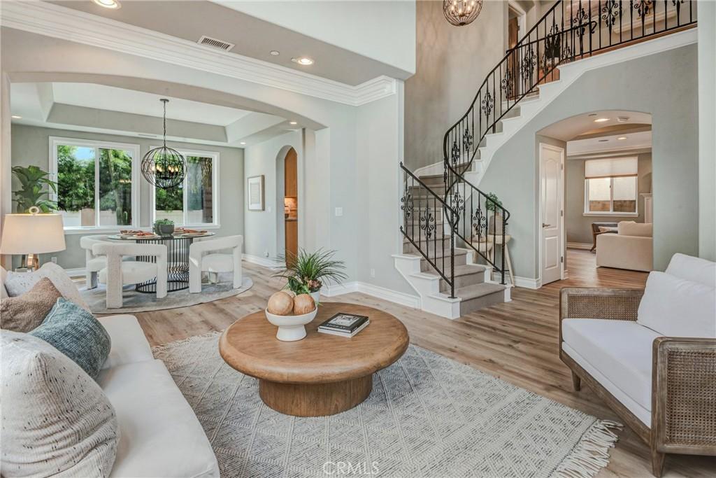 2116 Clark Ln Unit B, Redondo Beach, CA 90278 - living area with visible vents, arched walkways, a chandelier, stairway, and wood finished floors