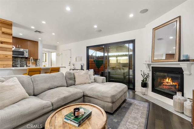 5545 Whitsett Ave Unit 1, Valley Village, CA 91607 - living room featuring dark wood-style flooring, visible vents, recessed lighting, and a fireplace with flush hearth