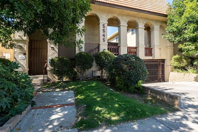 5545 Whitsett Ave Unit 1, Valley Village, CA 91607 - view of front facade featuring a tiled roof, stucco siding, and a front lawn