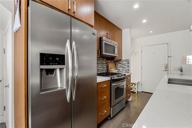 5545 Whitsett Ave Unit 1, Valley Village, CA 91607 - kitchen with a sink, light countertops, appliances with stainless steel finishes, and brown cabinets
