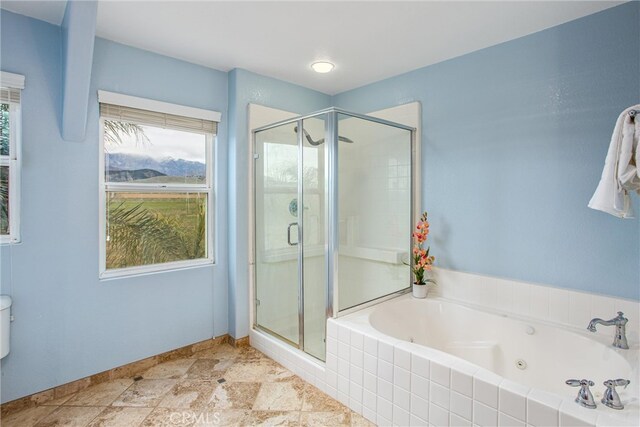 bathroom featuring a jetted tub and a stall shower