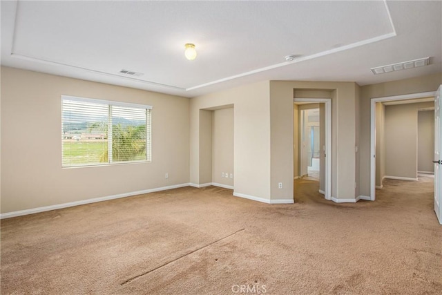 unfurnished bedroom featuring visible vents, baseboards, and carpet flooring