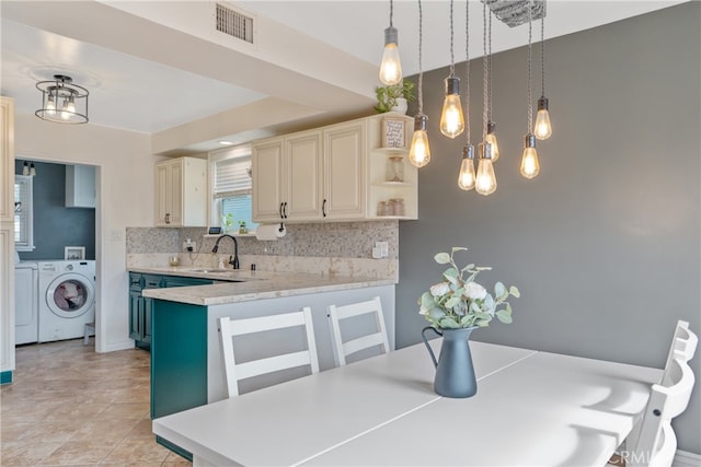 14844 Lull St, Van Nuys, CA 91405 - kitchen with washer and clothes dryer, open shelves, light countertops, backsplash, and pendant lighting
