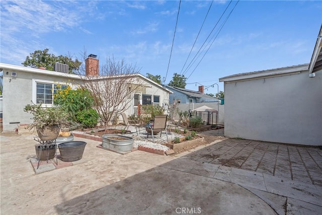 14844 Lull St, Van Nuys, CA 91405 - back of house featuring a chimney, a patio area, stucco siding, and a fire pit