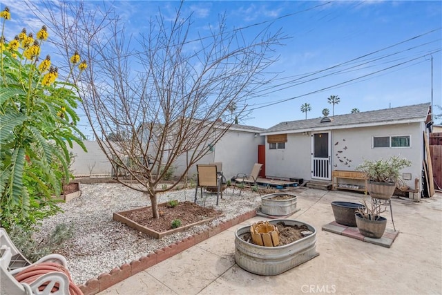 14844 Lull St, Van Nuys, CA 91405 - back of house featuring a fire pit, entry steps, fence, a patio, and stucco siding