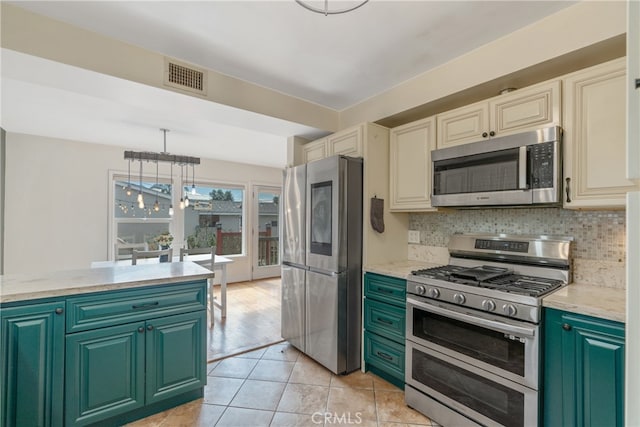 14844 Lull St, Van Nuys, CA 91405 - kitchen featuring appliances with stainless steel finishes, decorative backsplash, a chandelier, hanging light fixtures, and light tile patterned floors