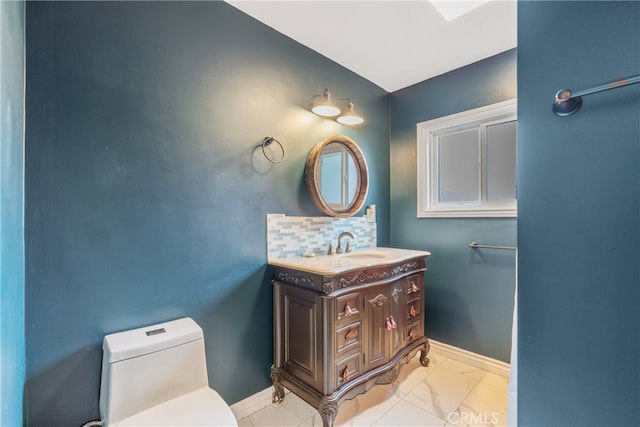 14844 Lull St, Van Nuys, CA 91405 - bathroom with vanity, baseboards, toilet, decorative backsplash, and marble finish floor