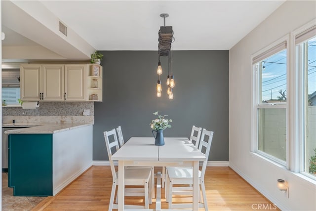 14844 Lull St, Van Nuys, CA 91405 - dining space with visible vents, light wood-style flooring, and baseboards