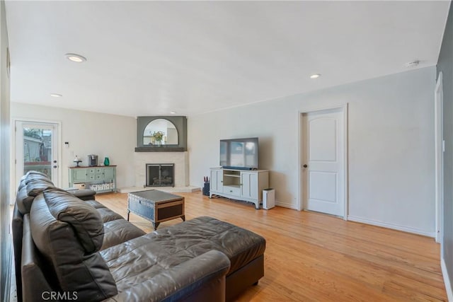 14844 Lull St, Van Nuys, CA 91405 - living room featuring light wood-type flooring, a fireplace, baseboards, and recessed lighting