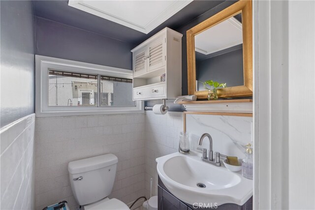 14844 Lull St, Van Nuys, CA 91405 - bathroom with tile walls, toilet, vanity, and a healthy amount of sunlight