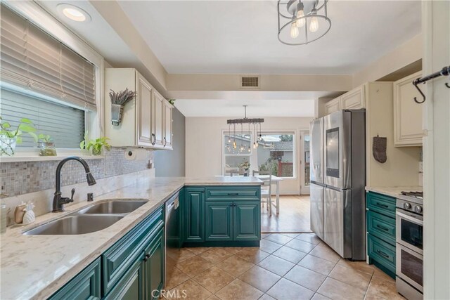 14844 Lull St, Van Nuys, CA 91405 - kitchen with appliances with stainless steel finishes, a chandelier, a peninsula, green cabinets, and backsplash