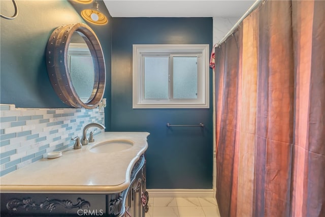 14844 Lull St, Van Nuys, CA 91405 - bathroom featuring marble look tiles, decorative backsplash, and vanity