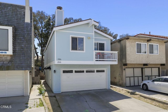 288 Highland Dr, Oxnard, CA 93035 - view of front of house with an attached garage, a chimney, a balcony, stucco siding, and driveway