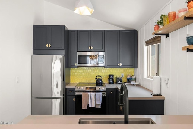 288 Highland Dr, Oxnard, CA 93035 - kitchen with open shelves, a sink, light countertops, vaulted ceiling, and stainless steel appliances