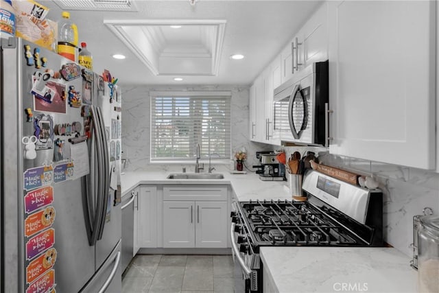 9876 Arrow Unit 1, Rancho Cucamonga, CA 91730 - kitchen featuring stainless steel appliances, a sink, recessed lighting, a tray ceiling, and white cabinets