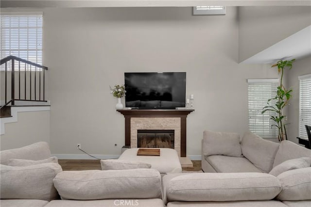 9876 Arrow Unit 1, Rancho Cucamonga, CA 91730 - living room with baseboards, wood finished floors, and a stone fireplace