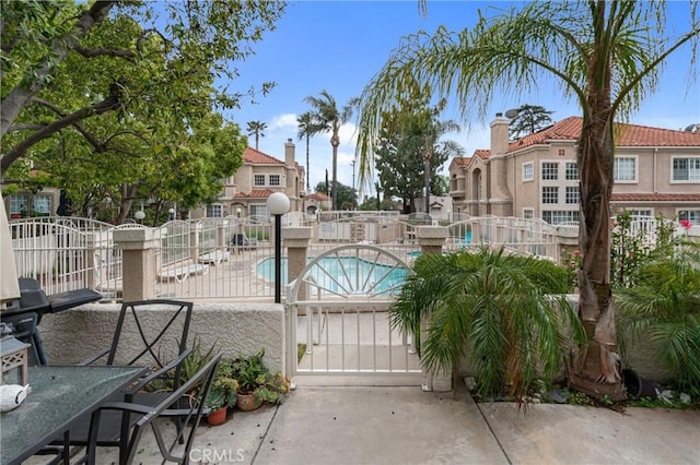 9876 Arrow Unit 1, Rancho Cucamonga, CA 91730 - community pool with a patio, a gate, and a residential view
