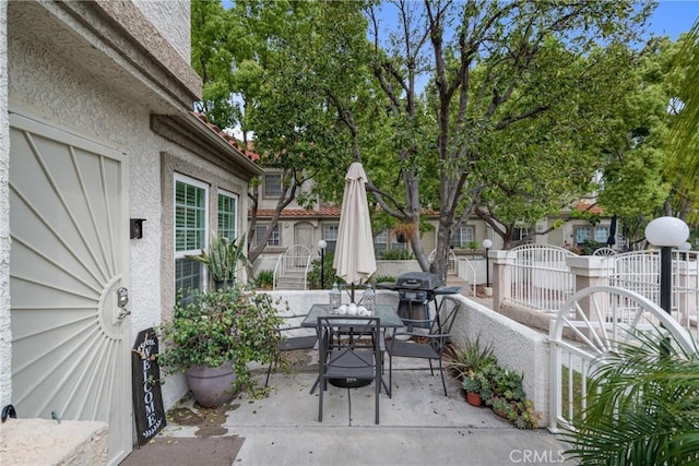 9876 Arrow Unit 1, Rancho Cucamonga, CA 91730 - view of patio with outdoor dining area, a grill, and a gate
