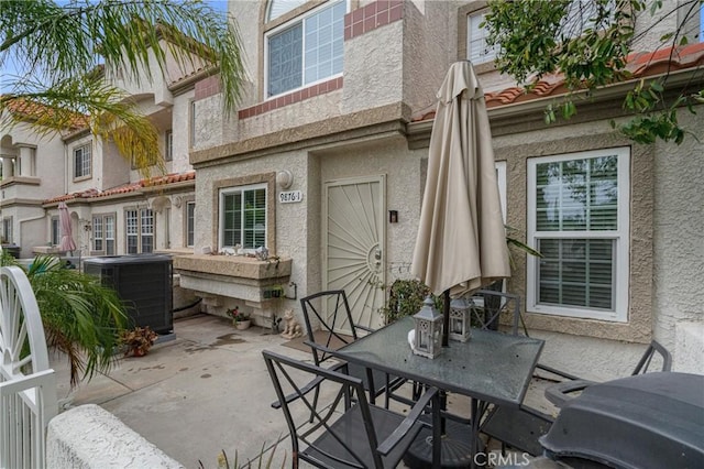 9876 Arrow Unit 1, Rancho Cucamonga, CA 91730 - view of patio featuring central AC unit and outdoor dining area