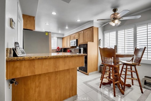 kitchen featuring recessed lighting, light tile patterned floors, a peninsula, ceiling fan, and appliances with stainless steel finishes