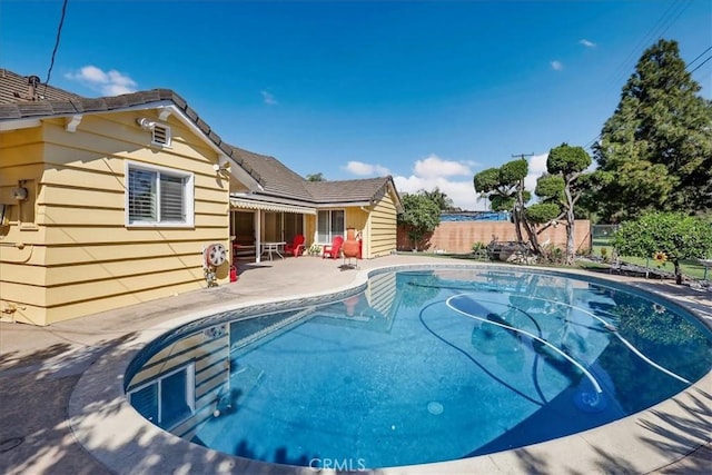 view of swimming pool featuring a fenced in pool, a patio area, and fence