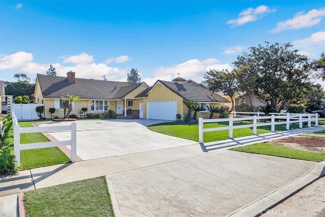 single story home with driveway, an attached garage, a front yard, a tiled roof, and fence