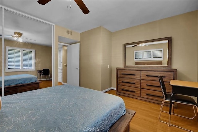bedroom featuring visible vents, a ceiling fan, and wood finished floors