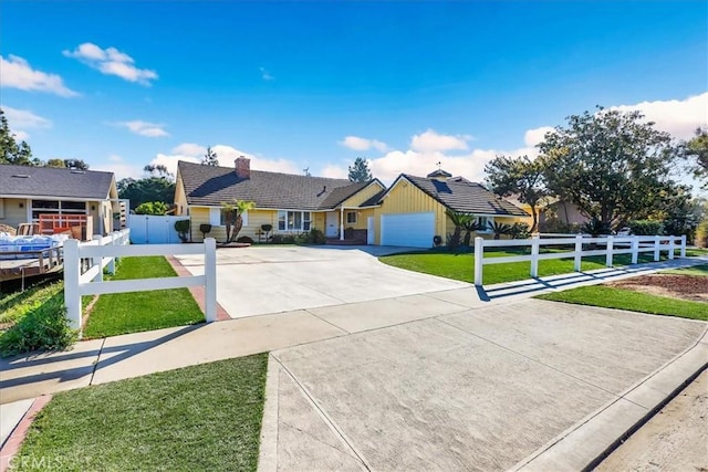 ranch-style home with a garage, fence, a tile roof, a front lawn, and concrete driveway