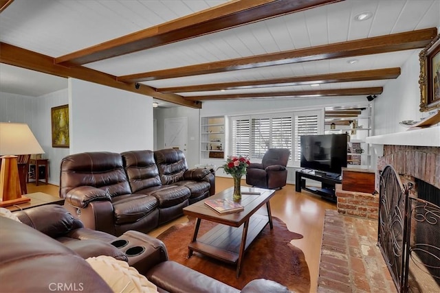 living room with beam ceiling, light wood-type flooring, recessed lighting, and a fireplace
