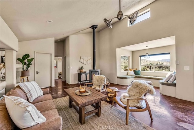 53105 Chia Trl, Pioneertown, CA 92268 - living room featuring high vaulted ceiling, a wood stove, baseboards, and a healthy amount of sunlight