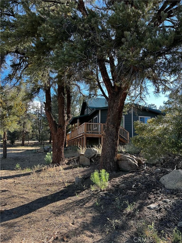 rear view of house with a deck and metal roof