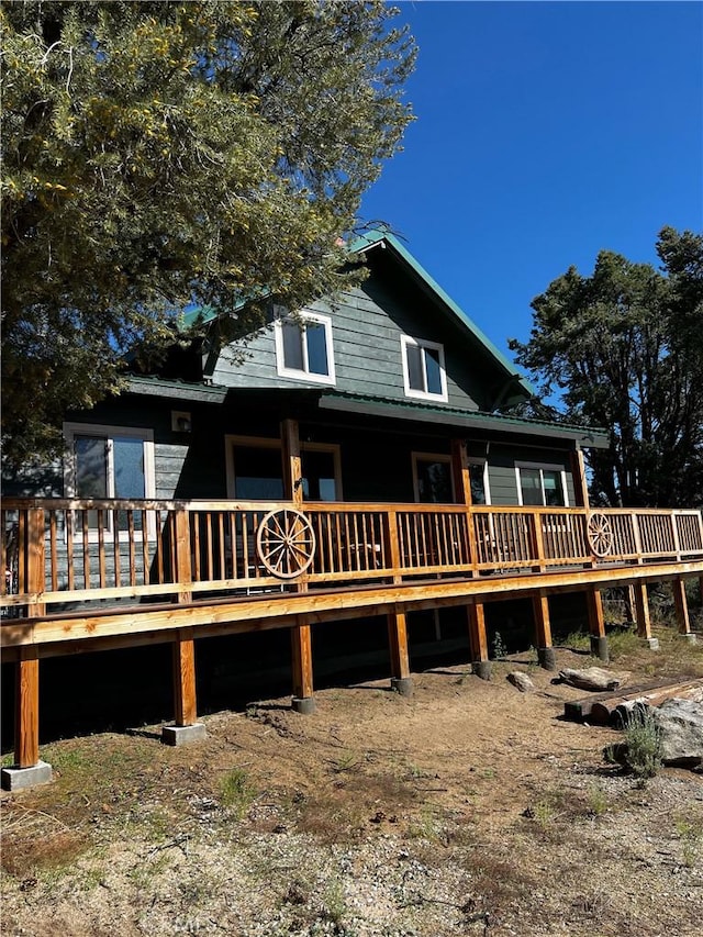 rear view of property featuring a deck