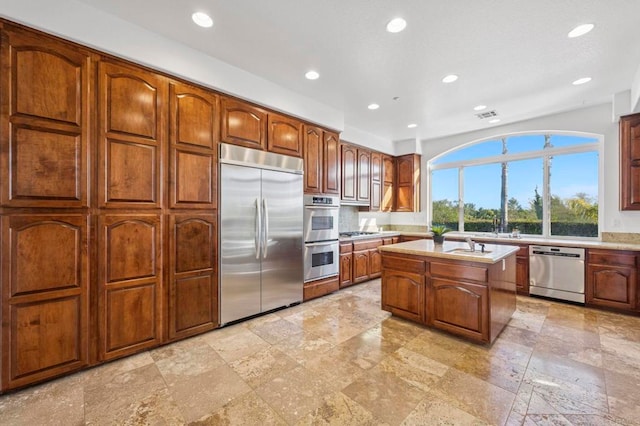 4033 Keri Way, Fallbrook, CA 92028 - kitchen featuring stainless steel appliances, stone tile flooring, recessed lighting, light countertops, and a center island