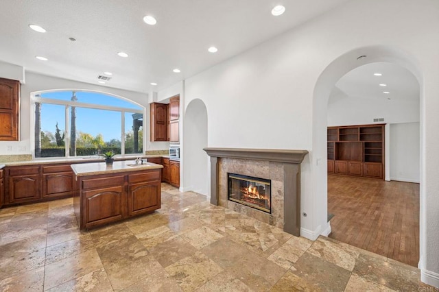 4033 Keri Way, Fallbrook, CA 92028 - kitchen featuring light countertops, recessed lighting, a center island, a tile fireplace, and stone tile flooring