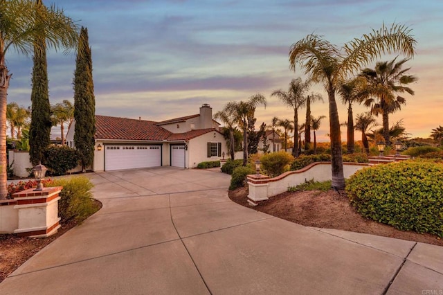 4033 Keri Way, Fallbrook, CA 92028 - mediterranean / spanish-style house featuring a garage, driveway, stucco siding, a chimney, and a tile roof