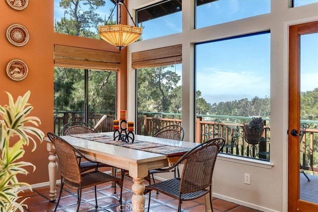 sunroom / solarium with baseboards and a healthy amount of sunlight
