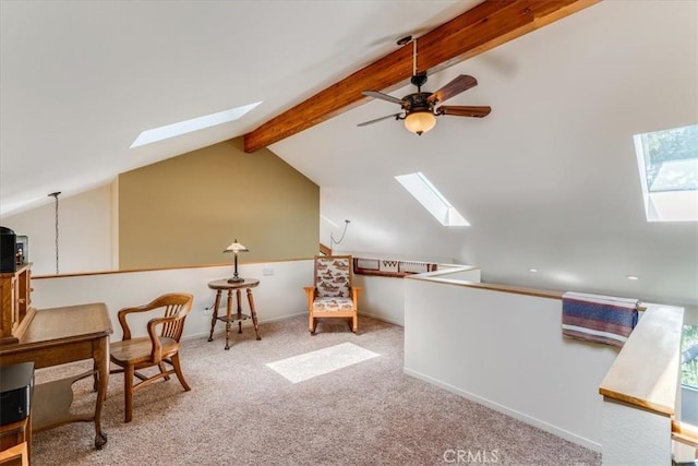 living area with baseboards, a ceiling fan, carpet, and lofted ceiling with skylight