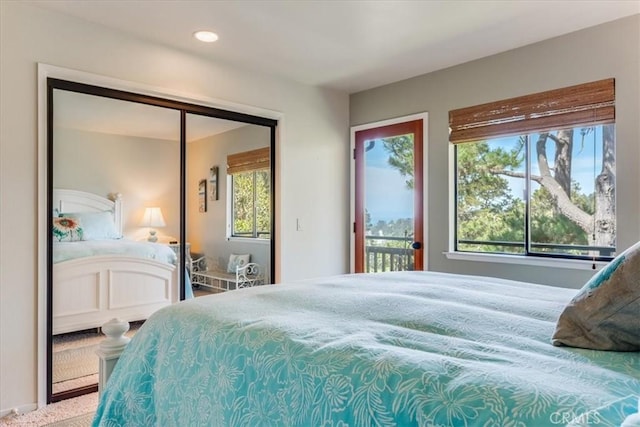 bedroom with recessed lighting, access to outside, multiple windows, and carpet floors