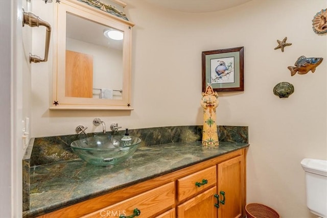 half bath featuring toilet and vanity