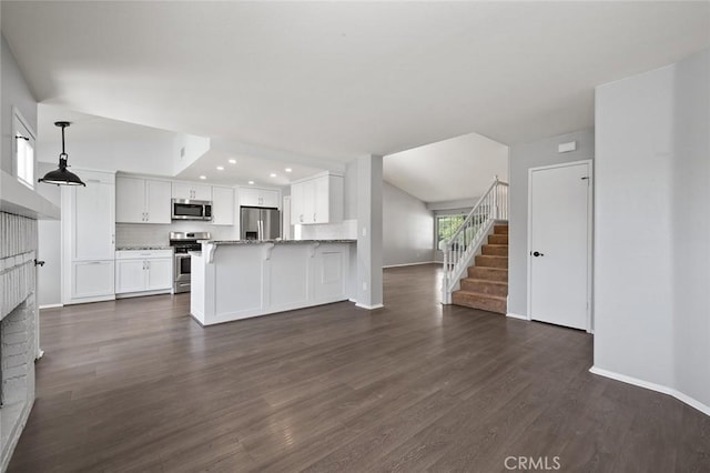 41564 Big Sage Ct, Temecula, CA 92591 - unfurnished living room featuring baseboards, recessed lighting, stairway, dark wood finished floors, and a fireplace
