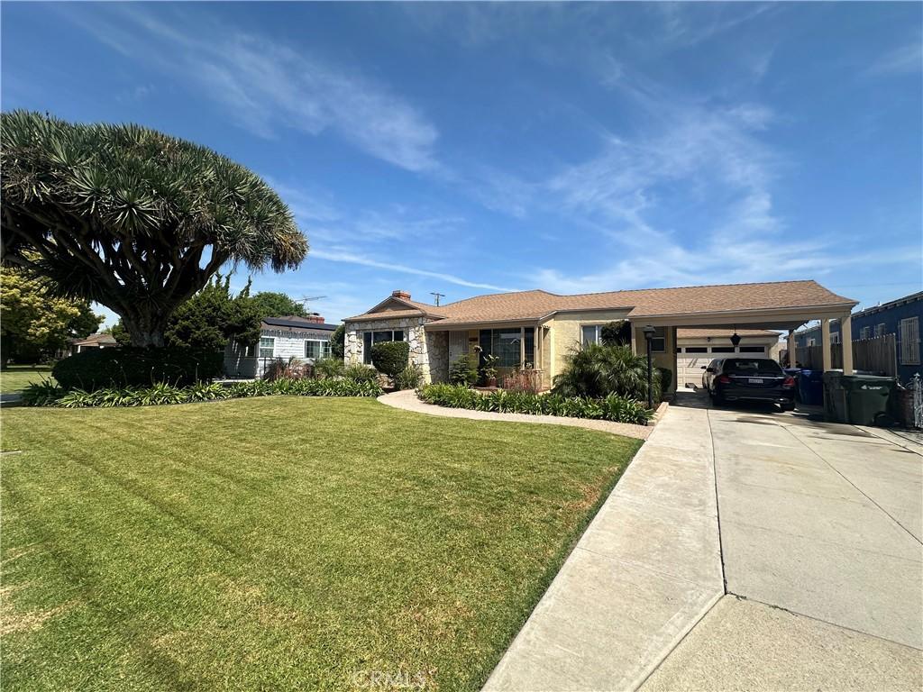 ranch-style home with an attached garage, driveway, and a front yard