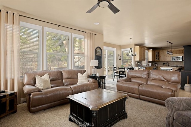 living area featuring recessed lighting, light colored carpet, and a ceiling fan