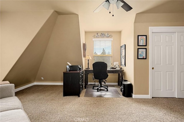carpeted home office featuring ceiling fan, vaulted ceiling, and baseboards