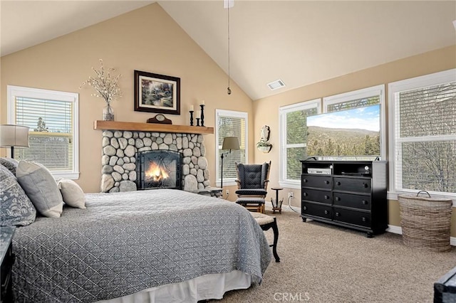 carpeted bedroom with a fireplace, visible vents, baseboards, and vaulted ceiling